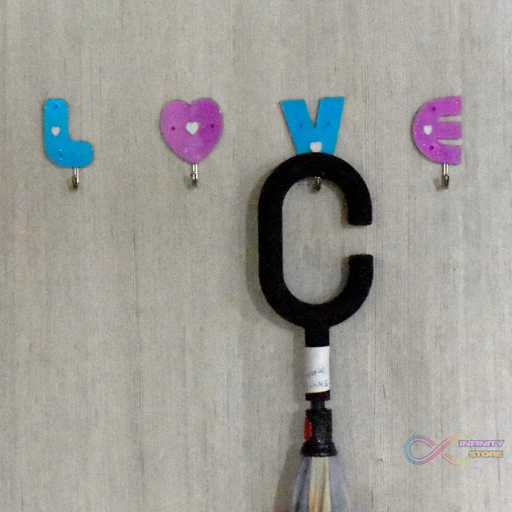 Adhesive hooks in love shape, ideal for home use.